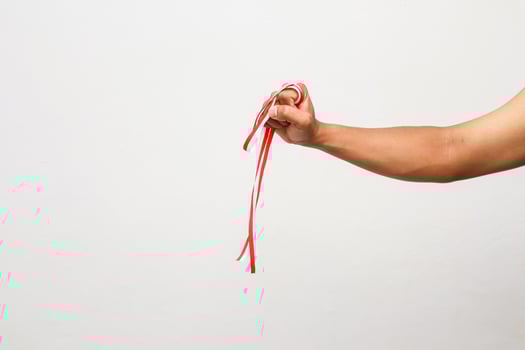 An Indonesian arm gripping a red and white ribbon celebrating independence day photo