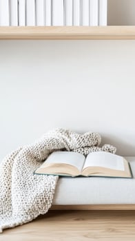 Cozy Reading Nook An Open Book and Soft Knitted Blanket on a Minimalist Bench with a Wooden Shelf, Evoking Tranquility and Leisure in a Bright Home Interior. photo