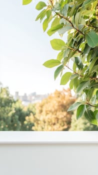 Vibrant green leaves frame a serene outdoor view with soft natural light, overlooking a tranquil blurred city skyline from a peaceful vantage point. photo