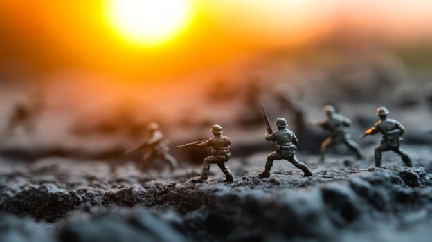 Miniature soldiers on a battlefield at sunset creating a dramatic military scene with soft lighting photo