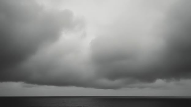 Cloudy overcast sky above serene ocean water at dusk with hints of distant horizon photo