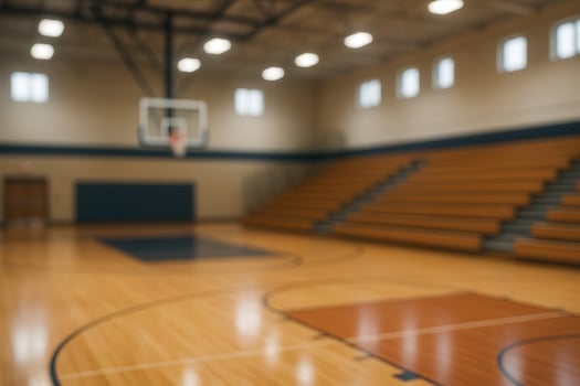 Pristine Gymnasium Interior With Wooden Basketball Court and Bleachers in Soft Light photo
