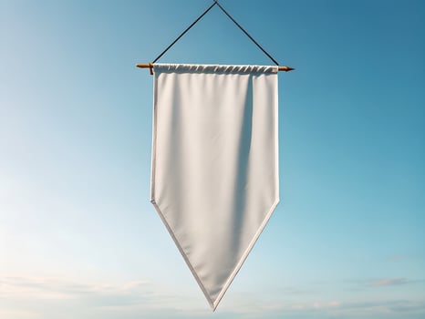 Blank White Pennant Hanging Against a Blue Sky photo