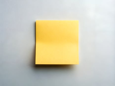 Blank Yellow Sticky Note on Grey Textured Background photo