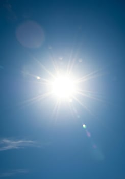 The sun shines brightly in a blue sky photo