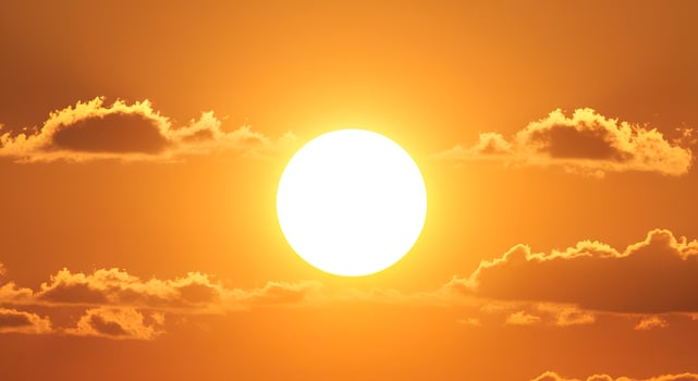 The sun is shining brightly in the sky photo