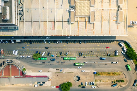 Tbilisi, Georgia - 11th july, 2025-Aerial top down view green buses and vehicles drive in station square by Tbilisi central railway station building photo