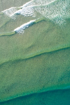 Layers of Green Water and White Waves from a Drone top down aerial drone view photo