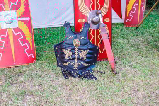 Ornate Roman Cuirass and Sword with Scutum Shields photo
