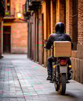 A man riding a motorcycle down a narrow alley photo