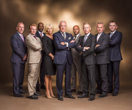 Group of business people in formal wear pose in studio photo