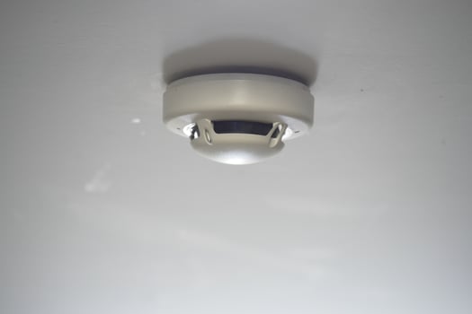 Smoke detector installed on a ceiling indoors photo