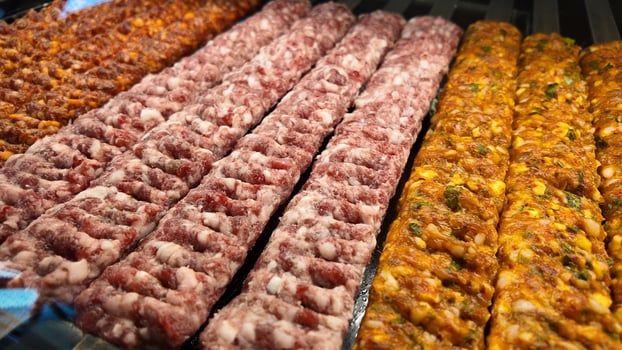 Grilled meat skewers displayed at a market food stall photo