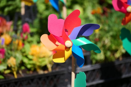 Colorful pinwheel spins in bright garden setting photo