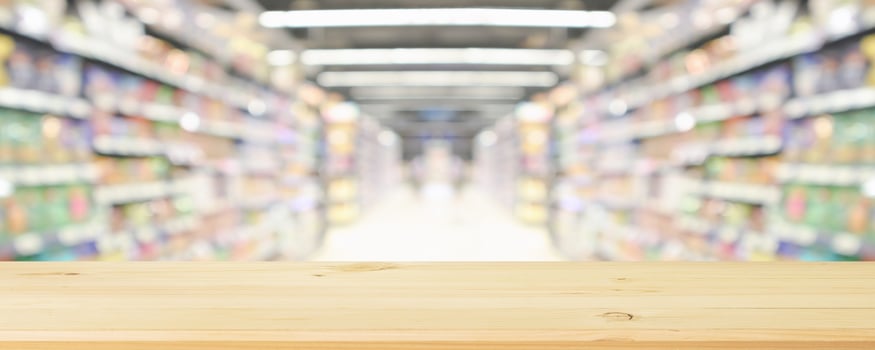 Empty wooden table in supermarket with blurred background photo
