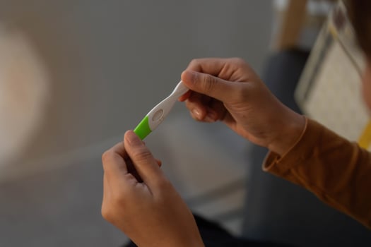 Pregnancy Test. Woman examining results with focus. photo