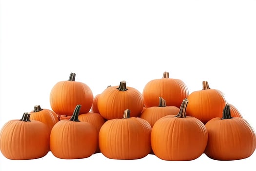 A pile of orange pumpkins with green stems on a white background in a studio setting view photo