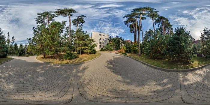 A 360 - view of a park with trees and buildings photo