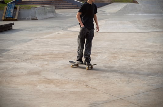 An unrecognizable skateboarder stands on a skateboard on a special skating area. This scene demonstrates the anticipation and skill needed to skateboard. High quality photo. photo