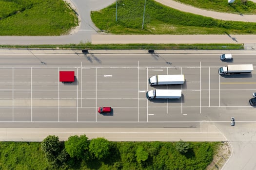 An aerial view of a busy road with cars and trucks photo