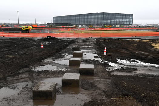 A construction site with a lot of dirt and construction equipment photo
