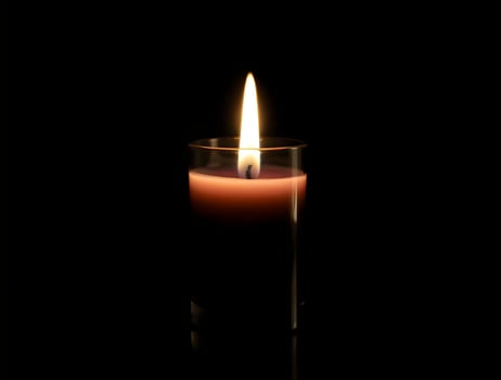Single Lit Candle in Glass Holder Against Black Background CloseUp Product Photography photo