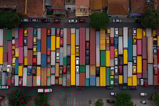 A large group of trucks parked in a parking lot photo