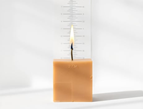 Lit Candle with Measurement Scale photo