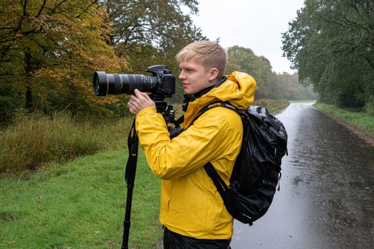 A man in a yellow jacket taking a picture of himself photo