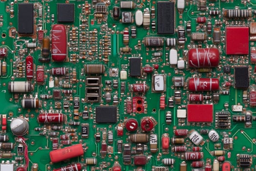 Electronic components on a green circuit board photo