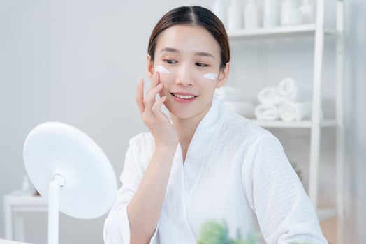 face of a healthy woman applying cream and makeup. Advertisement for skin cream, anti-wrinkle, baby face, whitening, moisturizer, tighten pores serum. photo