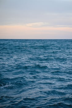 Blue ocean panorama with waves, vast open sea with clear sky. Idea for cold background and copy space photo
