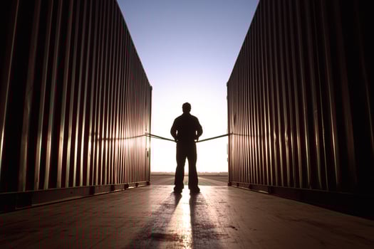A man standing in front of a shipping container photo