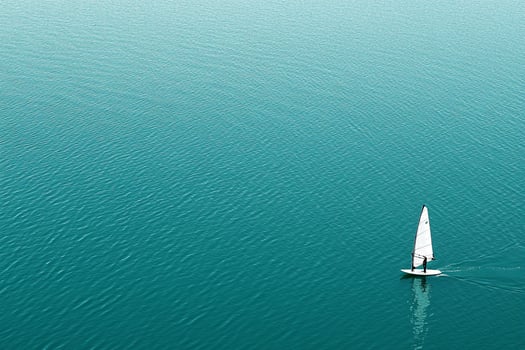 A sailboat in the middle of a large body of water photo