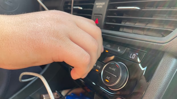 A person is holding a remote control in their hand photo
