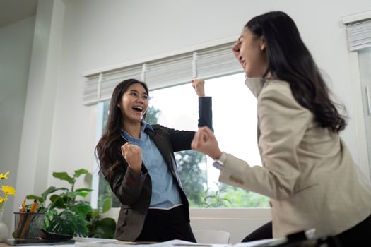 Celebrating Success. Two businesswomen expressing joy and excitement in the office. photo