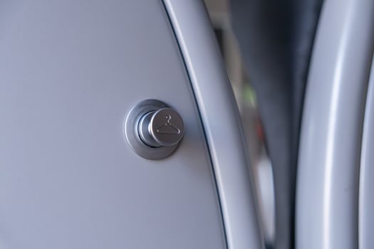 Contemporary silver button featuring a clothes hanger symbol, signifying smart laundry functionality for efficient garment care in modern home appliances photo