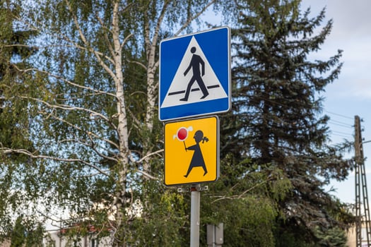 Prominent road signs displaying pedestrian crossing and child safety symbols, promoting crucial awareness and caution for drivers in an urban environment photo