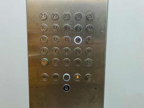 A highly polished stainless steel elevator control panel that features clearly labeled buttons corresponding to the numbers 1 through 12, providing easy access to various floors photo