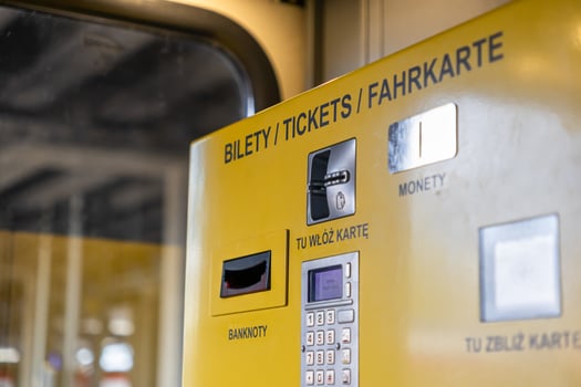 Yellow public transport ticket machine facilitates urban travel, accepts banknotes, coins, and cards, displaying TICKETS for convenient transactions photo