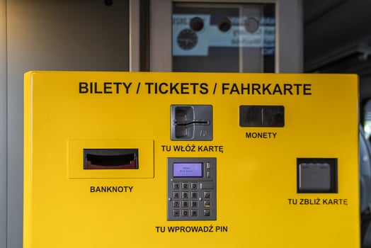 Bright automated ticket vending machine prominently displaying 'TICKETS' with diverse slots for cash, card insertion, and contactless payment, streamlining modern urban public transport solutions photo