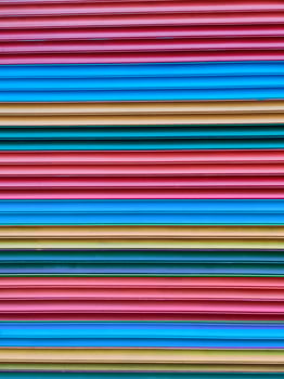 close-up of the texture of a corrugated multi-colored fence photo