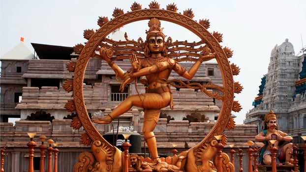 A statue of hindu god in a large frame photo