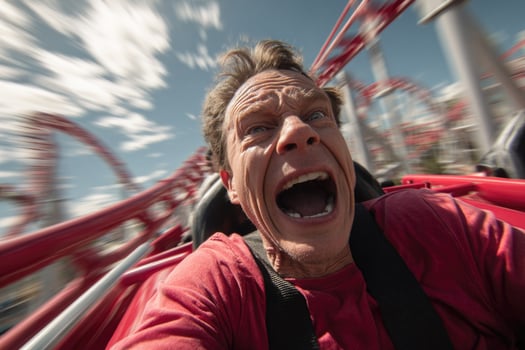 A man is screaming on a roller coaster photo