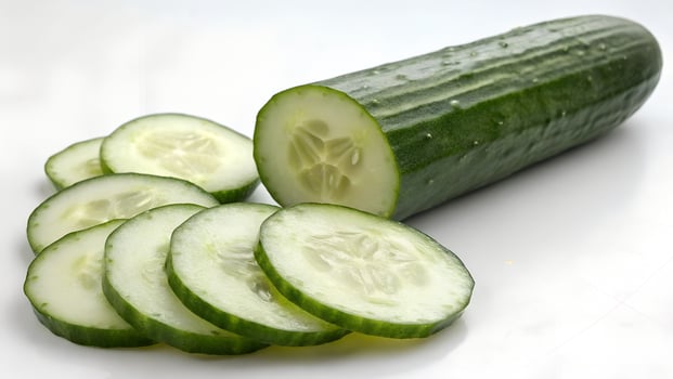 Realistic Clean Image of a Cucumber Sliced on White Surface photo