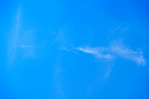 A stunning view of a bright blue sky with soft, wispy clouds. This serene image conveys tranquility and openness, making it perfect for backgrounds or creative projects. photo