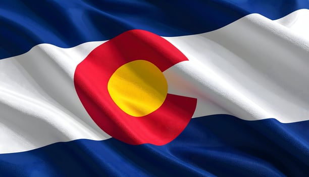 Close up of the waving state flag of Colorado, USA. Features a red C on blue and white stripes. A symbol of Colorado pride, travel, and the American West. photo