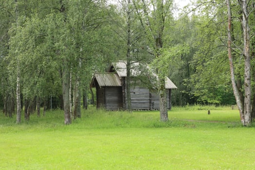 A Serene Wooden Cabin Nestled Beautifully Surrounded by Lush Greenery and Peaceful Scenery photo