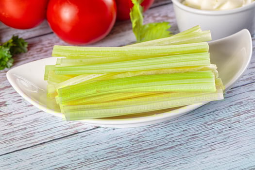 Celery leaves in a bowl with tomatoes and herbs photo