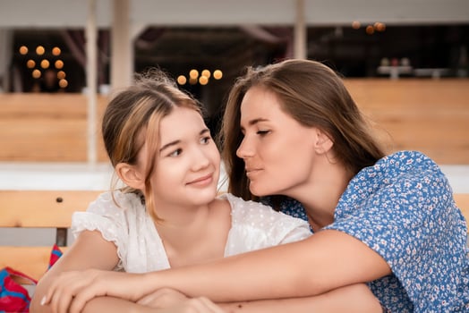 Sisters Affection Indoor Whispering. Close-up photo showing two sisters sharing a tender moment indoors, whispering secrets, conveying intimacy and affection.
